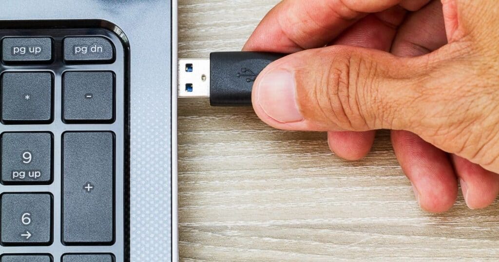 usb device being plugged into a laptop